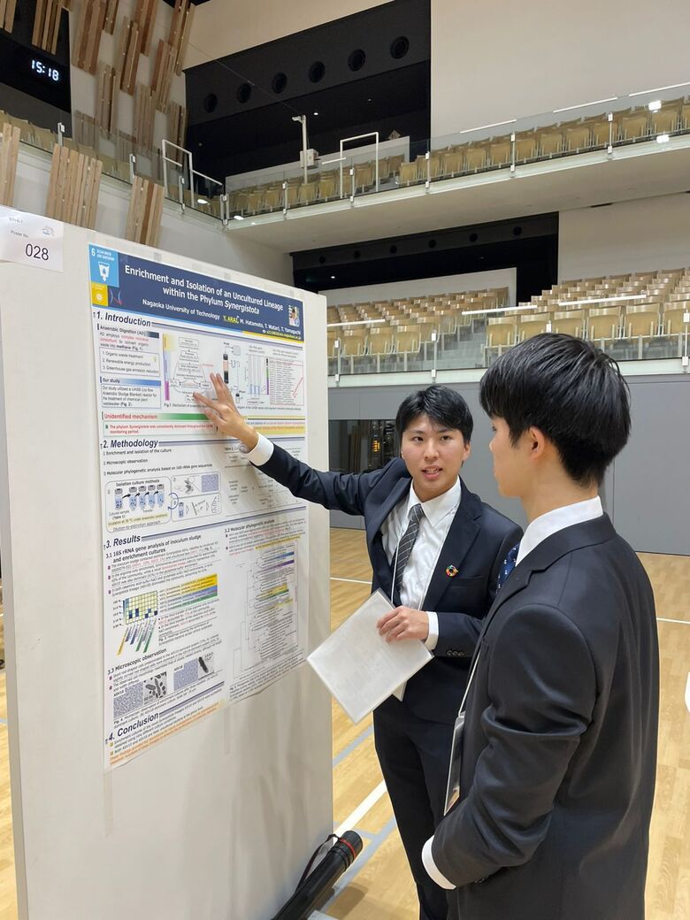 Enthusiastic presenters detailing their research findings